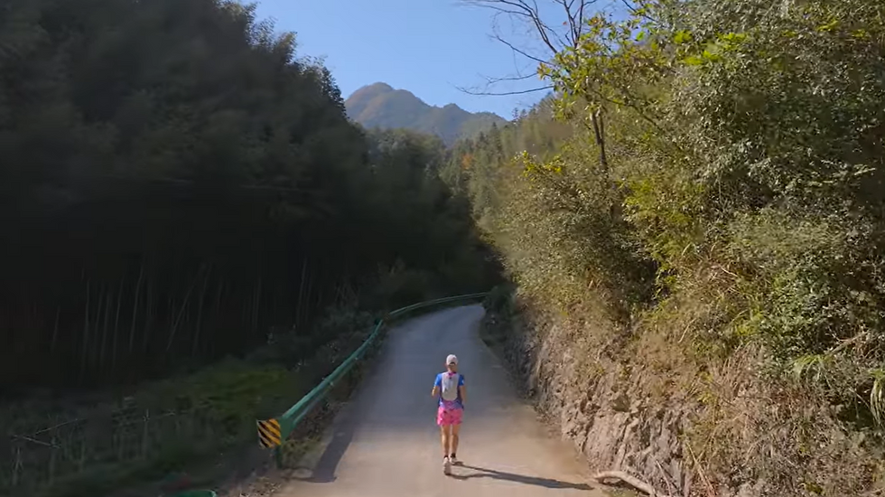 Eye-level view of a long winding road through mountainous terrain