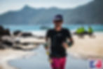 Jo Lodder competing in the HK100 ultra-marathon on a Hong Kong beach, representing elite endurance and local athletic performance.